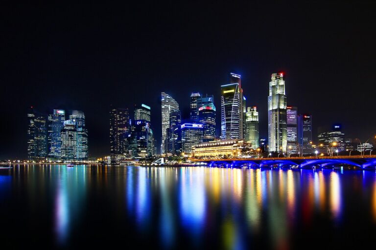 Singapore skyline illuminated at night with colourful reflections across the water